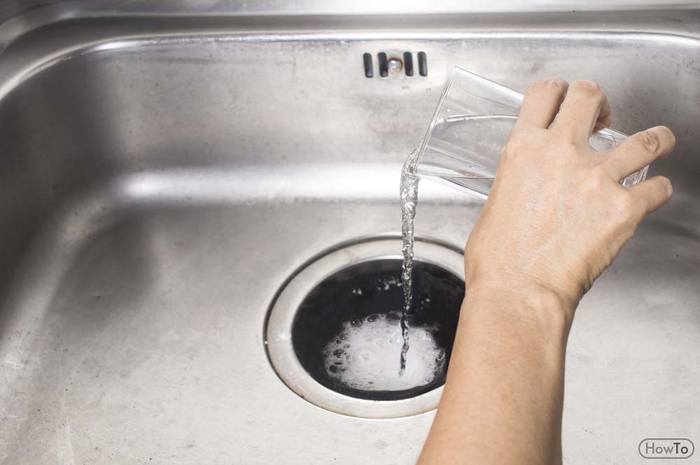 cleaning your kitchen sink with baking soda and vinegar